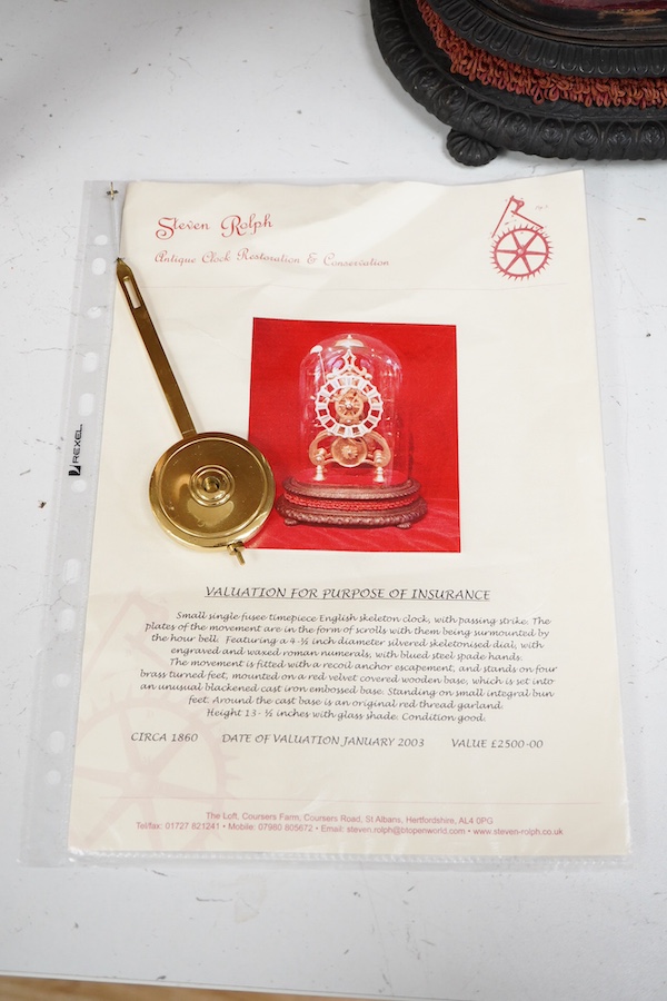 A Victorian skeleton clock under dome, cast iron base, 34cm total height